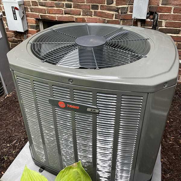 HVAC Maintenance page image New Trane HVAC unit connected to brick home